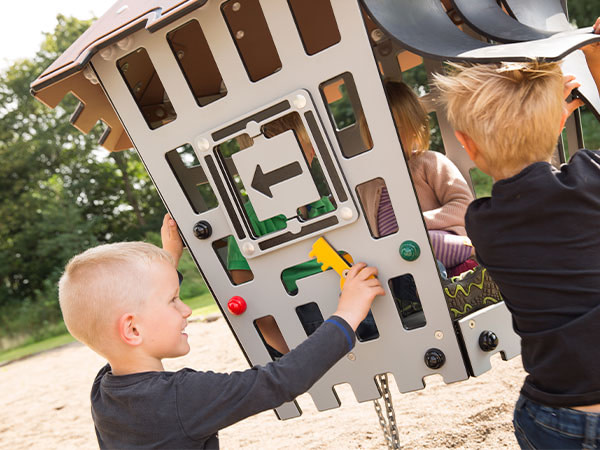 Dreng træner sin motorik på legepladsen og opnår både læring gennem leg og bevægelse.